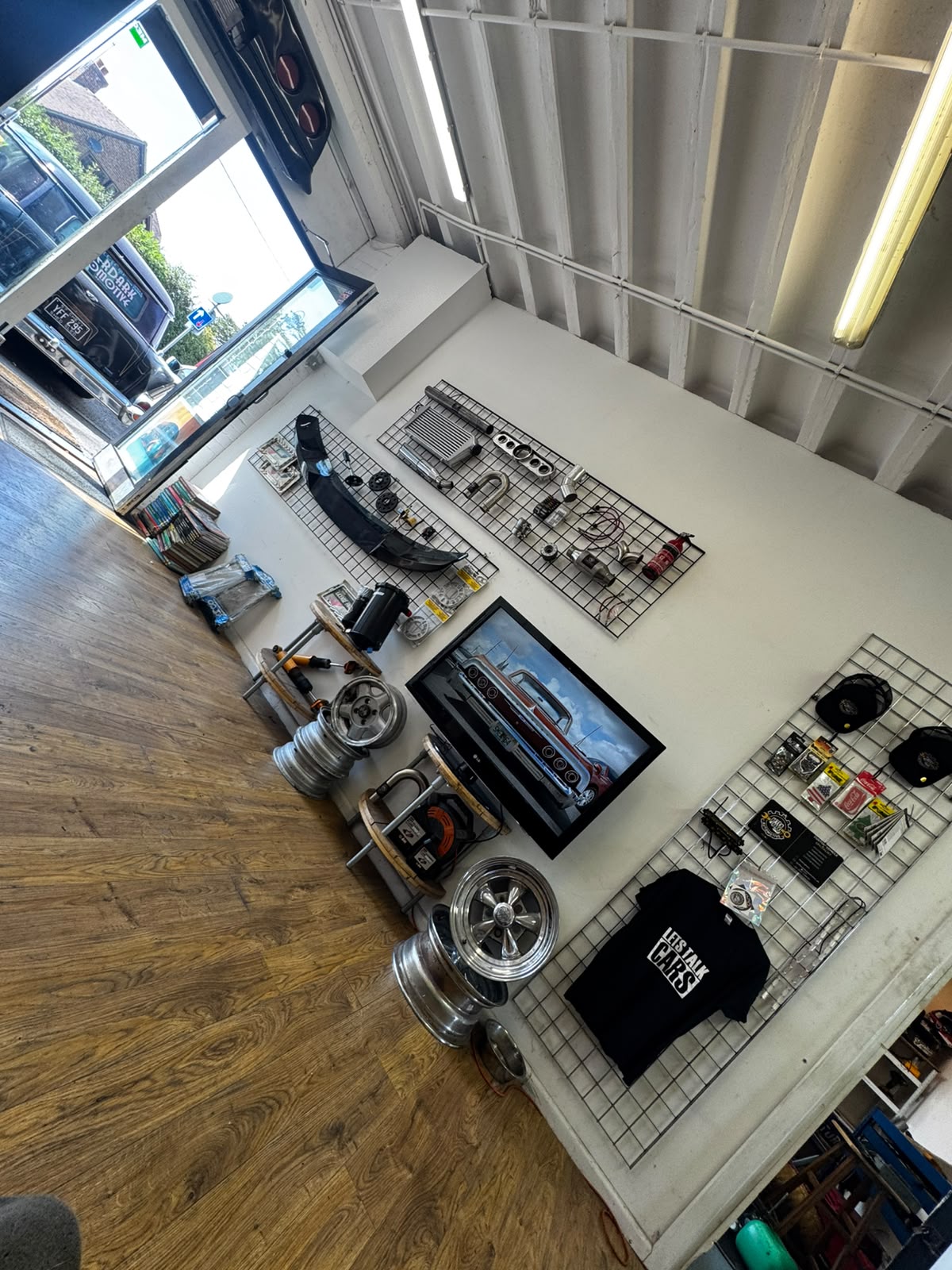 Inside the Afterdark Automotive reception, with parts, wheels and merch on the wall